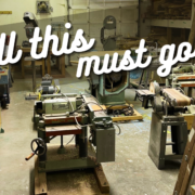 Photo of a large woodworking shop at Clay Tree, full of tools and equipment. Superimposed on top in diagonal text it says "All this must go!"