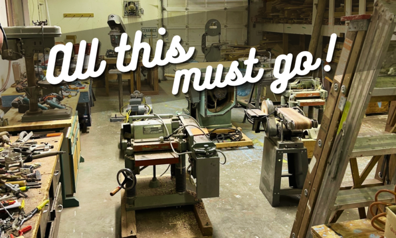 Photo of a large woodworking shop at Clay Tree, full of tools and equipment. Superimposed on top in diagonal text it says "All this must go!"